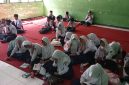 Siswa SMPN 2 Selong sedang mengikuti pelajaran tanpa kursi dan meja.