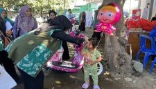 Ketua TP PKK Provinsi NTB Hj. Sinta Agathia M. Iqbal menyapa seorang anak dalam acara cegah stunting di Kantor Desa Pringgabaya Utara, Kecamatan Pringgabaya LombokTimur. (Foto: Lombokini.com)